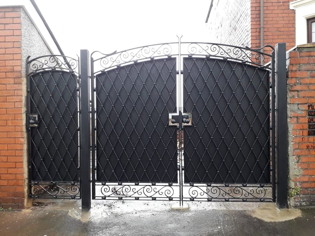 Wrought iron privacy gates with diamond lattice infill and scrollwork