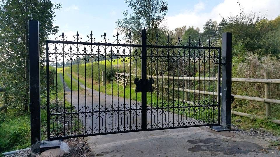 Ornate wrought iron estate gates with dense scrollwork