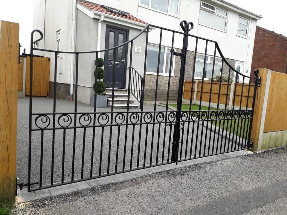 Wrought iron driveway gates with scroll detailing